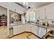 Efficient kitchen design featuring granite counters, stainless appliances, and open layout to dining area at 8680 Apache Plume Dr, Parker, CO 80134