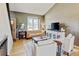 Bright living room with hardwood floors, comfortable seating, and large picture window at 8680 Apache Plume Dr, Parker, CO 80134