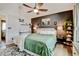 Well-lit main bedroom with a fan, accent wall, wall decor, and comfortable furnishings at 8680 Apache Plume Dr, Parker, CO 80134