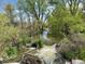 Picturesque water feature with small waterfall surrounded by lush greenery at 8680 Apache Plume Dr, Parker, CO 80134