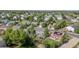 A beautiful aerial view of a neighborhood with mature trees and well-maintained homes with established landscaping at 5434 S Rome St, Aurora, CO 80015