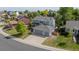 Aerial view of a spacious suburban home with a large driveway and well-kept landscaping at 5434 S Rome St, Aurora, CO 80015