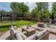 Landscaped backyard featuring a patio area with outdoor seating and a trampoline at 5434 S Rome St, Aurora, CO 80015