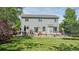Expansive backyard with a patio, dining area, fire pit, and lush green lawn at 5434 S Rome St, Aurora, CO 80015