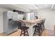Finished basement with a kitchenette, barstool seating, stainless steel refrigerator, and a cozy, modern feel at 5434 S Rome St, Aurora, CO 80015