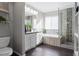 Modern bathroom showcasing a double vanity, soaking tub, and a glass-enclosed shower with stylish tile accents at 5434 S Rome St, Aurora, CO 80015