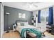 Bright bedroom with a modern ceiling fan, a large window, and stylish furniture creating a relaxing space at 5434 S Rome St, Aurora, CO 80015
