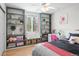 Cozy bedroom with built-in shelves, a window seat, and a comfortable bed, perfect for relaxation and storage at 5434 S Rome St, Aurora, CO 80015