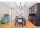 Inviting dining room with hardwood floors, stylish lighting, and elegant furnishings for memorable gatherings at 5434 S Rome St, Aurora, CO 80015