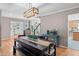 Open-concept dining area with hardwood floors, modern light fixture, and seamless flow to other living spaces at 5434 S Rome St, Aurora, CO 80015
