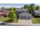 Aerial view of a two-story home with a three-car garage and a well-manicured lawn at 5434 S Rome St, Aurora, CO 80015