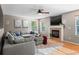 Cozy living room features a fireplace, plush sectional sofa, and bright windows for a welcoming atmosphere at 5434 S Rome St, Aurora, CO 80015