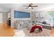 Spacious living room boasts a comfortable sectional sofa, stylish decor, and hardwood flooring for a relaxing retreat at 5434 S Rome St, Aurora, CO 80015