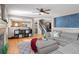 Open-concept living room with hardwood floors, sectional sofa, and seamless flow to the kitchen and dining area at 5434 S Rome St, Aurora, CO 80015