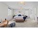 Serene main bedroom with carpet, ample windows, and a seating area, creating a relaxing retreat at 5434 S Rome St, Aurora, CO 80015