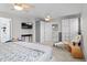 Spacious main bedroom featuring neutral tones, multiple ceiling fans, closet, and seating, offering a calming retreat at 5434 S Rome St, Aurora, CO 80015