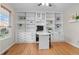 Bright home office with custom built-in shelving, drawers, and a sleek, curved desk for a functional workspace at 5434 S Rome St, Aurora, CO 80015