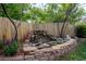 Backyard water feature with stone accents and lush plantings, creating a tranquil garden setting at 5434 S Rome St, Aurora, CO 80015