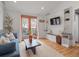 Bright living room featuring hardwood floors, stylish built-ins, shiplap accent wall, and sliding glass doors to the outdoor space at 6795 W 29Th Ave, Wheat Ridge, CO 80214