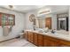 Bathroom with a double sink vanity, and a large mirror creating an open and airy atmosphere at 533 Tenderfoot Dr, Larkspur, CO 80118