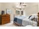 Comfortable bedroom with natural light, dresser, and a cozy bed with blue and white bedding at 533 Tenderfoot Dr, Larkspur, CO 80118
