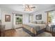 Bright bedroom with serene views featuring neutral colors, wood floors and ceiling fan at 533 Tenderfoot Dr, Larkspur, CO 80118