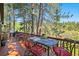 Relax on the spacious deck featuring outdoor dining and grill, surrounded by beautiful pine trees at 533 Tenderfoot Dr, Larkspur, CO 80118