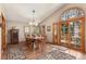 Elegant dining room with vaulted ceilings and access to the private outdoor balcony at 533 Tenderfoot Dr, Larkspur, CO 80118