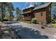 Charming two-story home with a cozy porch and well-maintained landscaping along the driveway at 533 Tenderfoot Dr, Larkspur, CO 80118