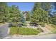 Beautiful two-story home with a well-manicured front yard and privacy from mature trees at 533 Tenderfoot Dr, Larkspur, CO 80118