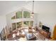 Spacious living room with soaring windows, vaulted ceilings, and great natural light at 533 Tenderfoot Dr, Larkspur, CO 80118