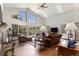 Open living room featuring vaulted ceilings, a cozy fireplace, and large windows at 533 Tenderfoot Dr, Larkspur, CO 80118
