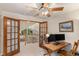 Bright home office featuring double doors, natural light, and a wooden desk setup for productivity at 533 Tenderfoot Dr, Larkspur, CO 80118