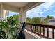 Enjoy the outdoors from this balcony with a telescope, offering views of lush trees and neighborhood scenery at 5757 W Alamo Dr, Littleton, CO 80123