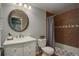 Updated bathroom with stylish vanity, modern fixtures, and tiled bath and shower at 5757 W Alamo Dr, Littleton, CO 80123