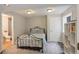 Bedroom with plush carpet, neutral walls, and a view of a tiled bathroom with shower at 5757 W Alamo Dr, Littleton, CO 80123