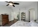 Bright bedroom featuring a ceiling fan, a comfortable bed with floral patterned cover, and a charming wooden dresser at 5757 W Alamo Dr, Littleton, CO 80123