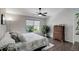 Cozy bedroom with a large window, a comfortable bed with floral patterned cover, and a charming wooden dresser at 5757 W Alamo Dr, Littleton, CO 80123