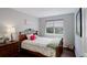 Cozy bedroom features a floral comforter, wood accents, and bright natural light at 5757 W Alamo Dr, Littleton, CO 80123
