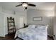 Comfortable bedroom featuring a ceiling fan, a large window, and a stylishly decorated bed at 5757 W Alamo Dr, Littleton, CO 80123