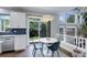 Bright dining area with a modern light fixture, access to the backyard, and stylish decor at 5757 W Alamo Dr, Littleton, CO 80123