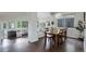 Open-concept dining area with hardwood floors, a large table, and adjacent living spaces at 5757 W Alamo Dr, Littleton, CO 80123