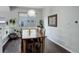 Cozy dining room with a wooden table, seating for six, and natural light at 5757 W Alamo Dr, Littleton, CO 80123
