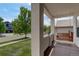 Covered front porch featuring a wooden porch swing and views of the front yard at 5757 W Alamo Dr, Littleton, CO 80123