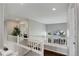 Upstairs hallway with a plant, a window, and white wooden railings at 5757 W Alamo Dr, Littleton, CO 80123
