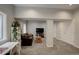 Spacious living room with plush carpeting, stylish furniture, and a view of the yard at 5757 W Alamo Dr, Littleton, CO 80123