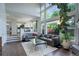Open concept living room boasting high ceilings, large windows offering natural light, and stylish furniture at 5757 W Alamo Dr, Littleton, CO 80123