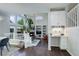 Open-concept living room with built-in shelves, a fireplace, and a cozy workspace at 5757 W Alamo Dr, Littleton, CO 80123