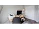 Office space with a desk, printer, lamp, and an organized closet, perfect for a productive work environment at 5757 W Alamo Dr, Littleton, CO 80123
