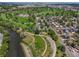 Aerial view showcases the property's proximity to a golf course, green spaces, and the city skyline at 2253 S Fox St, Denver, CO 80223